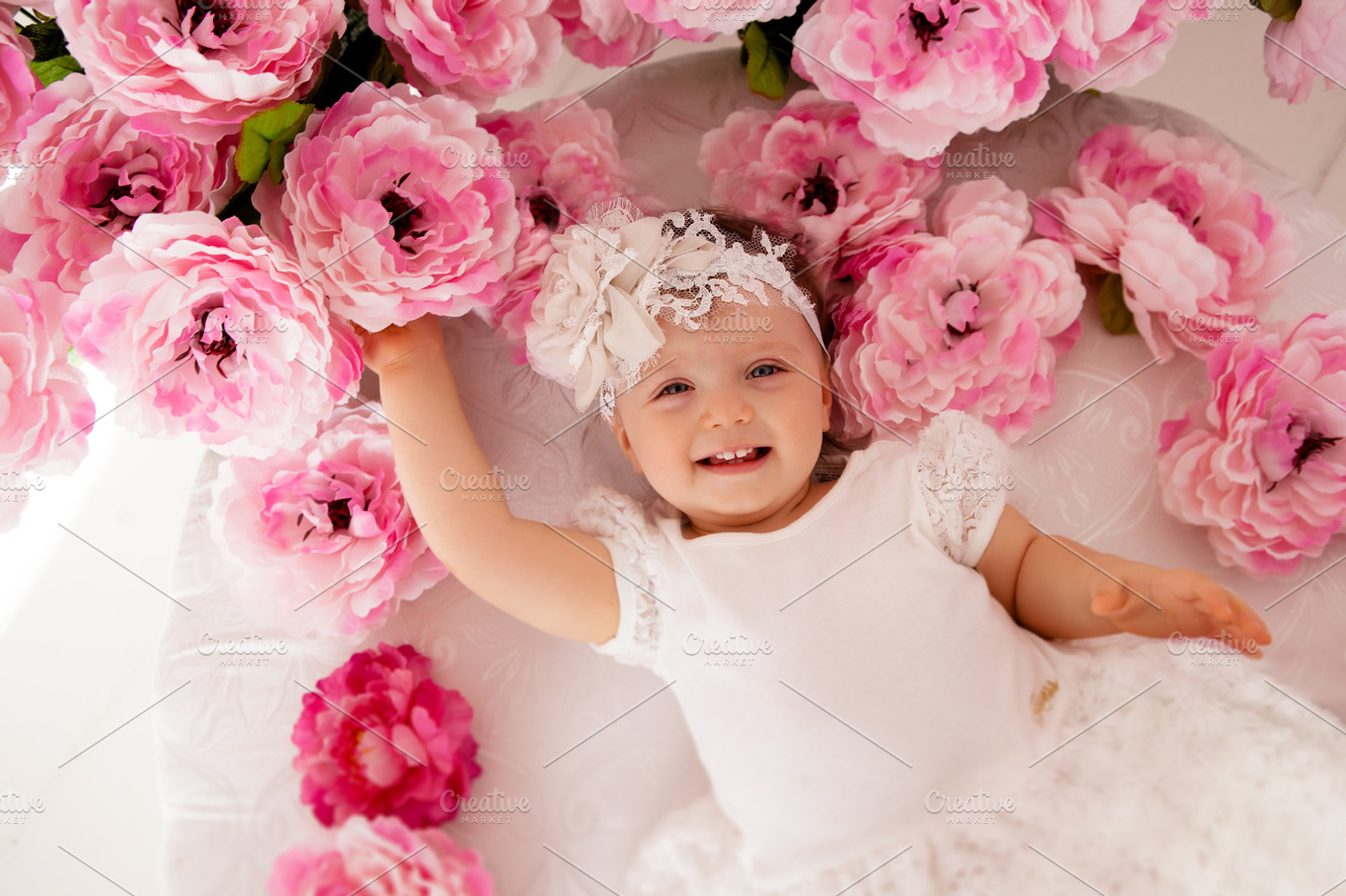 Baby girl lying on her stomach stock photo containing adorable and baby, a Person Photo by SaulichPhoto
