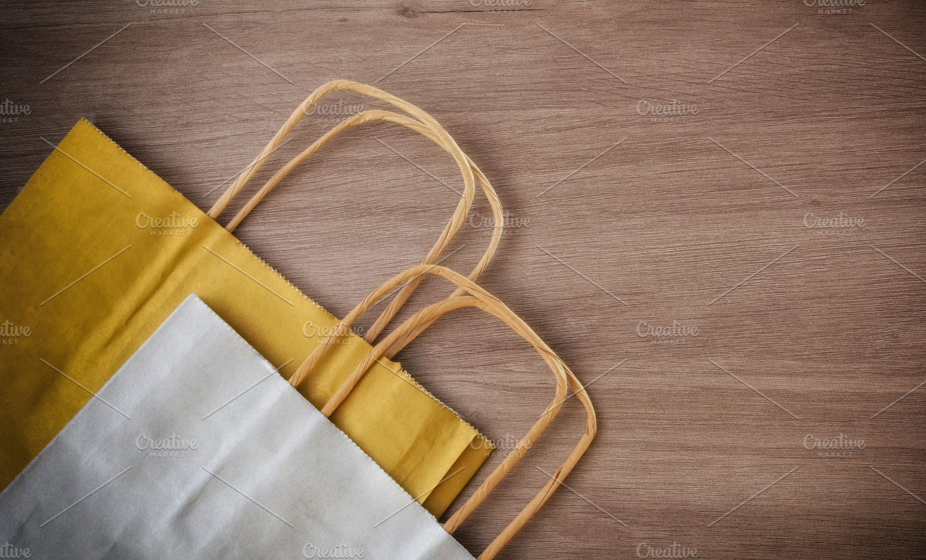 Detail of two paper shopping bag on wooden table, a Holiday Photo by Davizro's Market