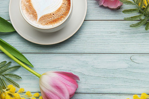 Cappuccino with heart shaped foam near pink tulips and mimosa fl, a Holiday Photo by Olena Rudo