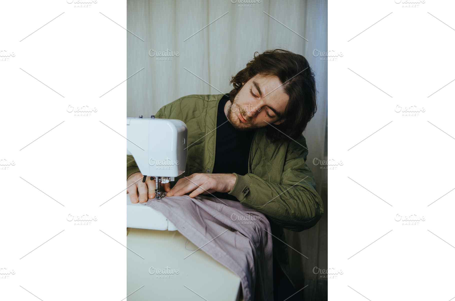 man sews on a typewriter at home, a Person Photo by zheckasmk