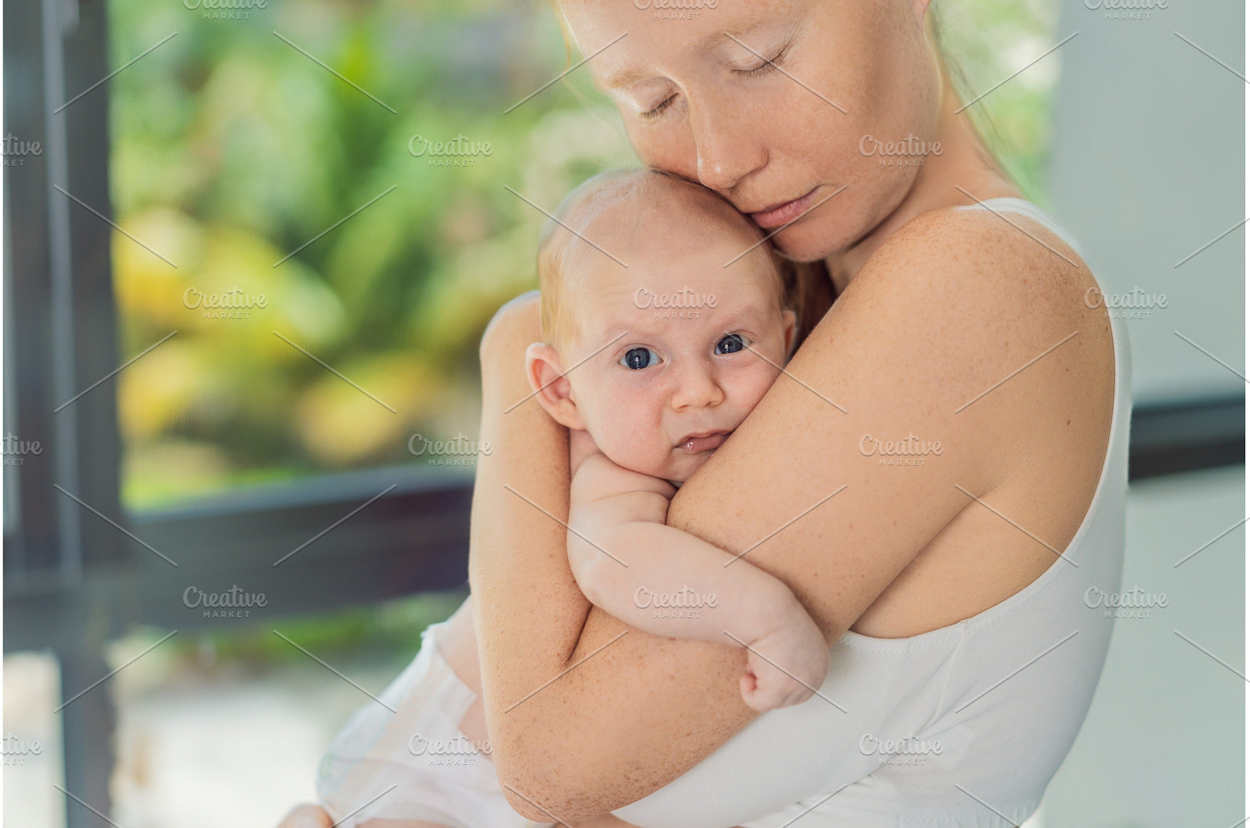 Mother gently hugging her baby at, a Beauty & Fashion Photo by Elizaveta Galitskaya