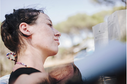 Young woman reading a book in a park, a Holiday Photo by Manu Reyes