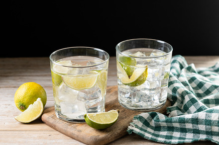 Glass of vodka tonic cocktail on wooden table, a Food & Drink Photo by etorres69