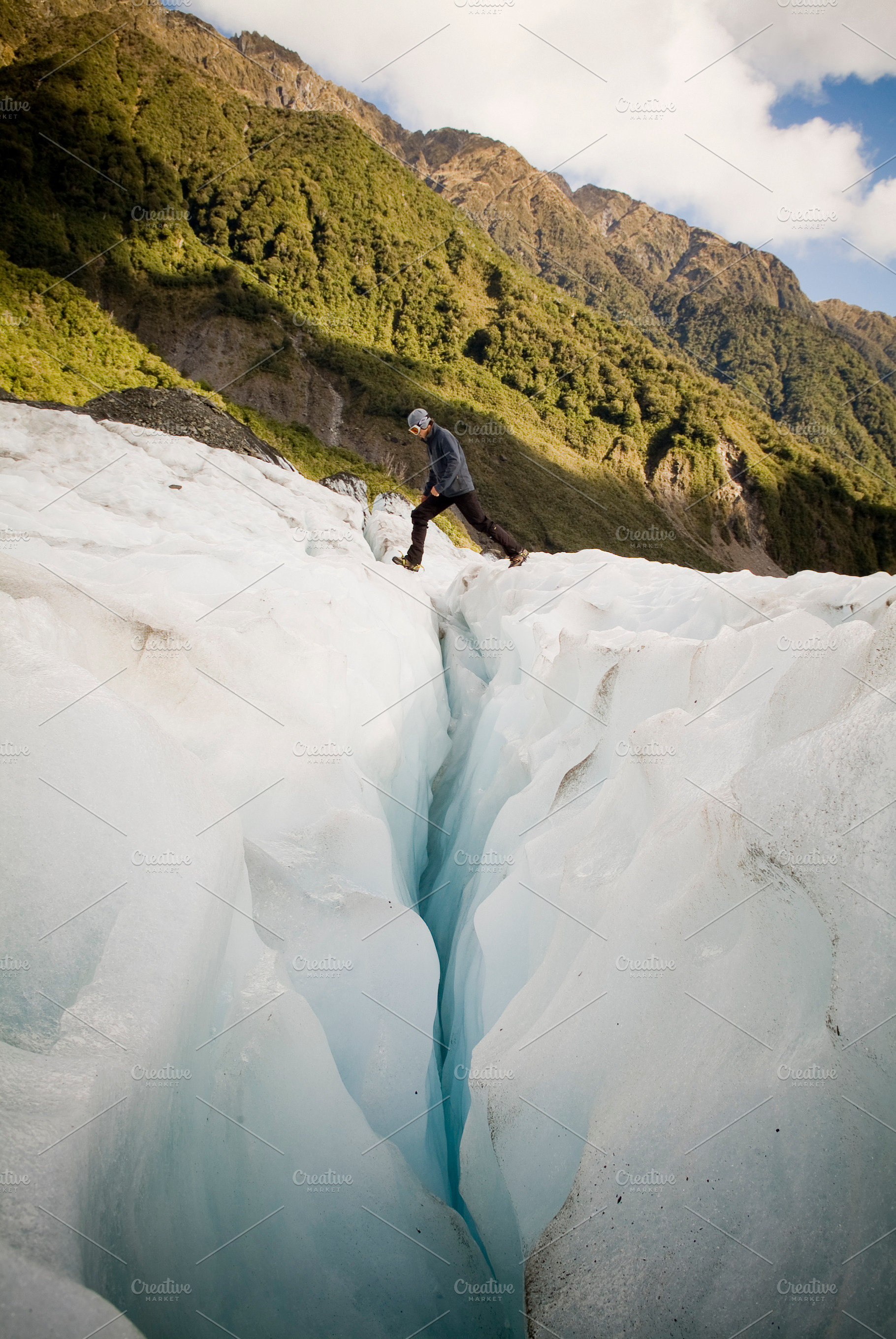 Ice Climber Crossing Crevasse, a Person Photo by THP Creative