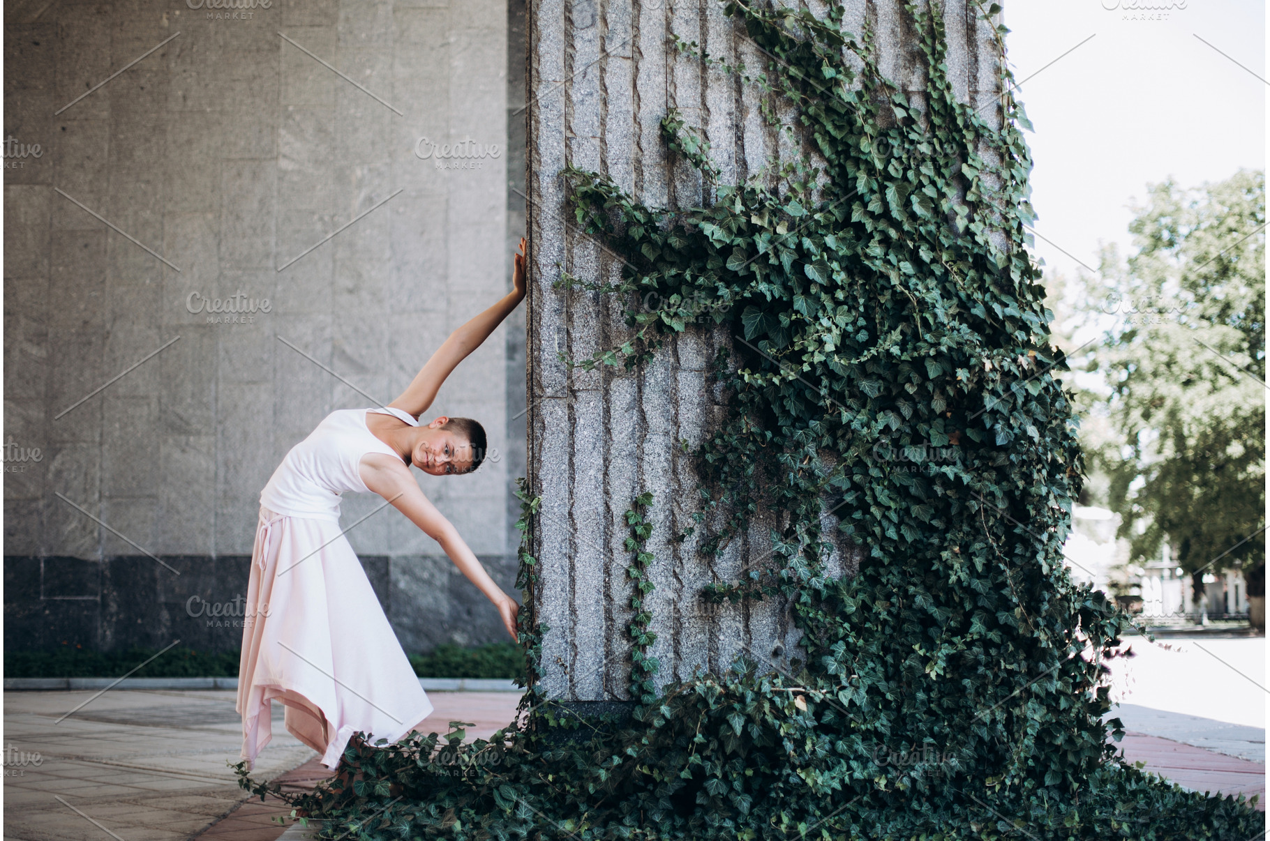 Woman dancing gracefully against ivy, a Person Photo by Anna Efetova