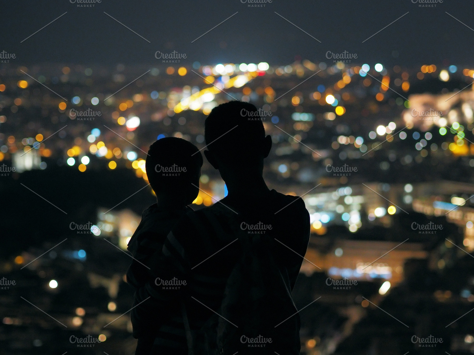 Father and son featuring father and son, look at the night city, and, a Person Photo by EkaterinaPlanina