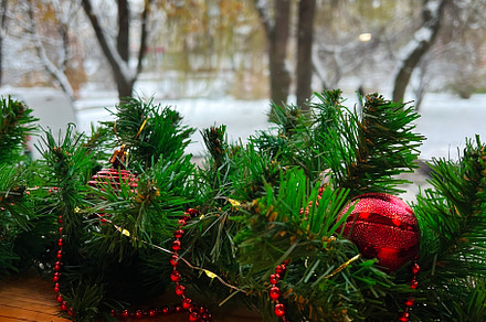 Festive Christmas garland decorating a window sill in winter, a Photo by AS photostudio