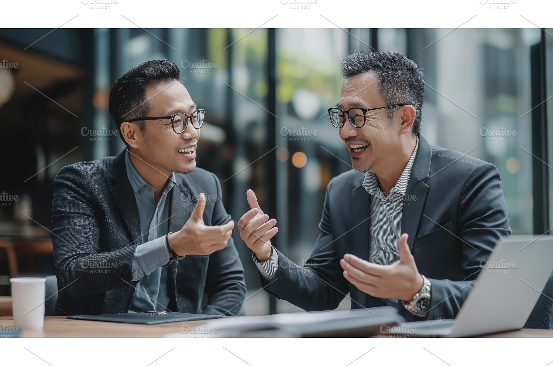 Two Asian businessmen engaged in a, a Person Photo by Sergey Kotenev