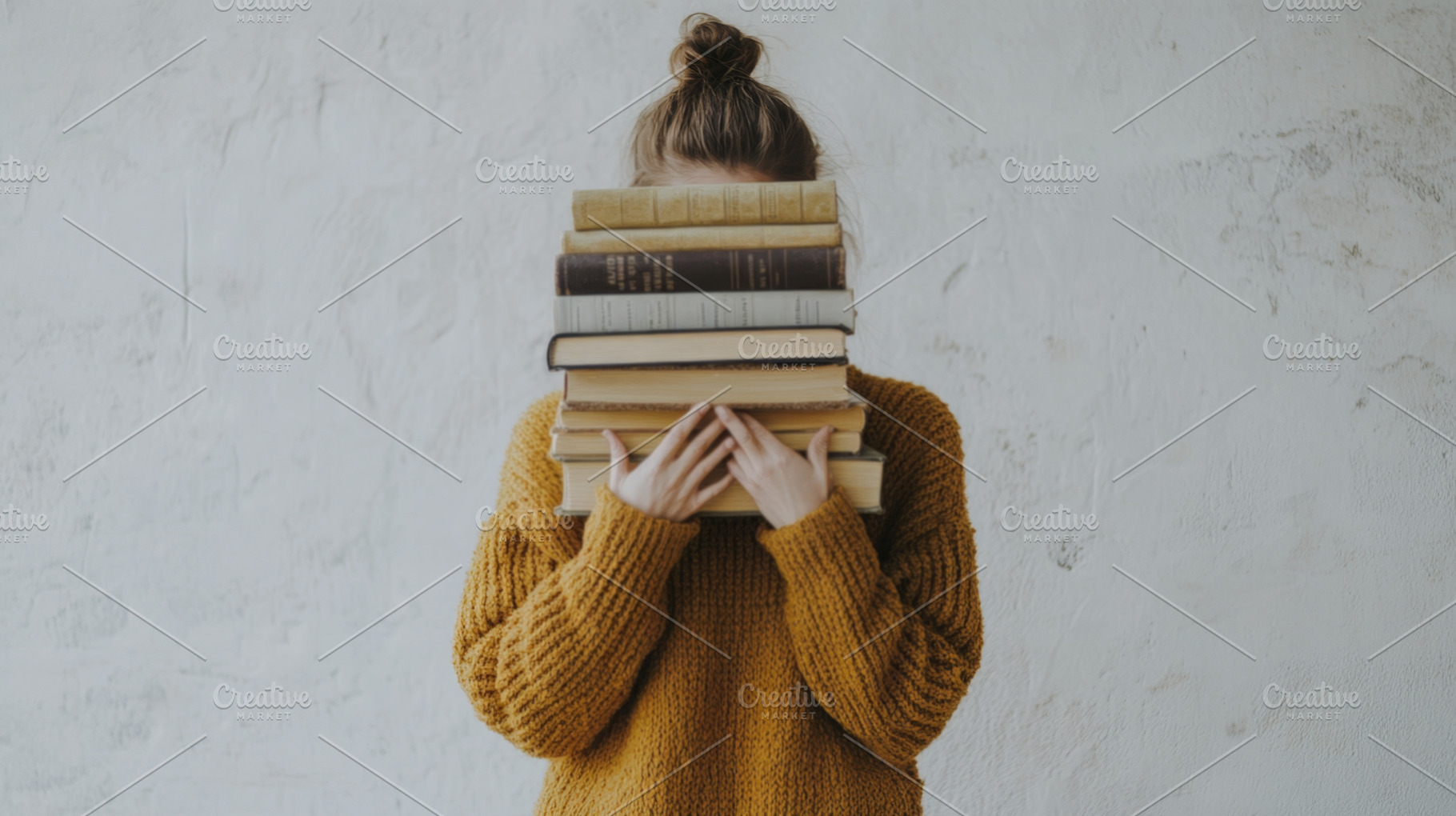 Woman Holding a Stack of Books in Cozy Knit Sweater, an Abstract Photo by Natalia Klenova's Shop