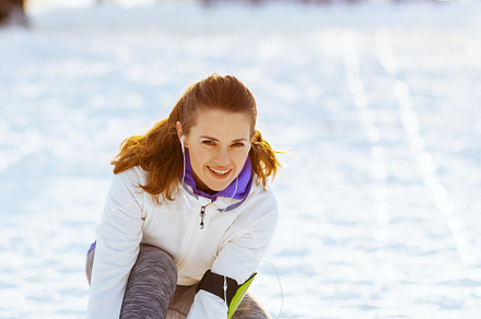 smiling active woman in white jacket tying your shoelaces, a Sports & Recreation Photo by Alliance Images