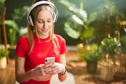 smiling female in red fitness clothes in green house, a Person Photo by Alliance Images