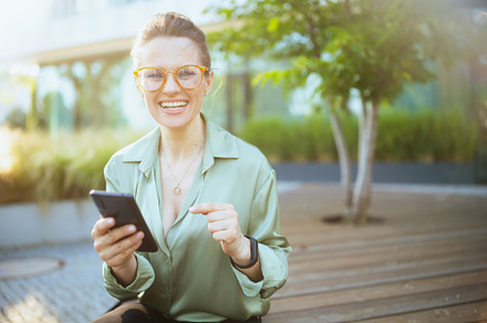 happy modern business woman in green blouse and eyeglasses, a Person Photo by Alliance Images