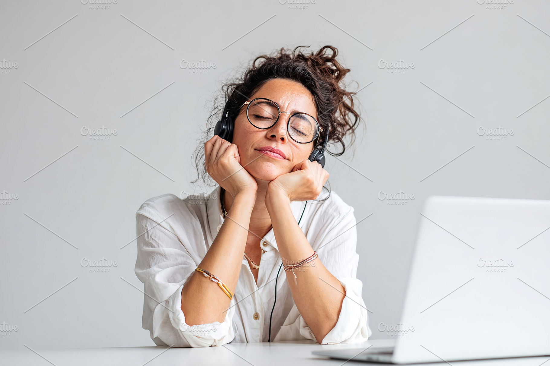 Professional woman in headset focuses on work at a modern office environment, a Person Photo by AlyaAnd