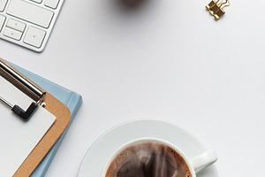 Office worker desk with coffee, keyboard, glasses, plant and not, a Business Photo by Olena Rudo