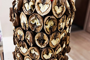 Rustic walnut shell centerpiece made from dried shells with heart shapes and pi, a Photo by AS photostudio