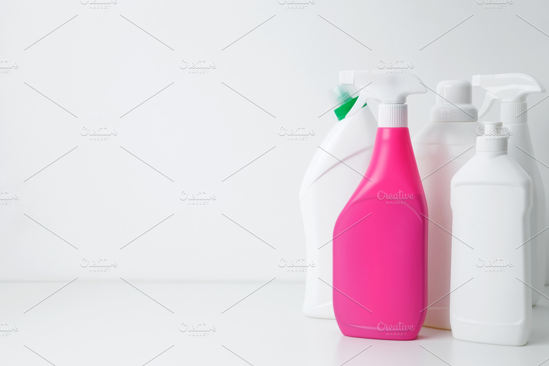 Various cleaning supplies on white background symbolizing spring cleaning. Hous, a Photo by matucha