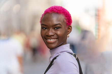 Modern and young woman smiling to the camera, a Person Photo by Iván Moreno STOCK PHOTO