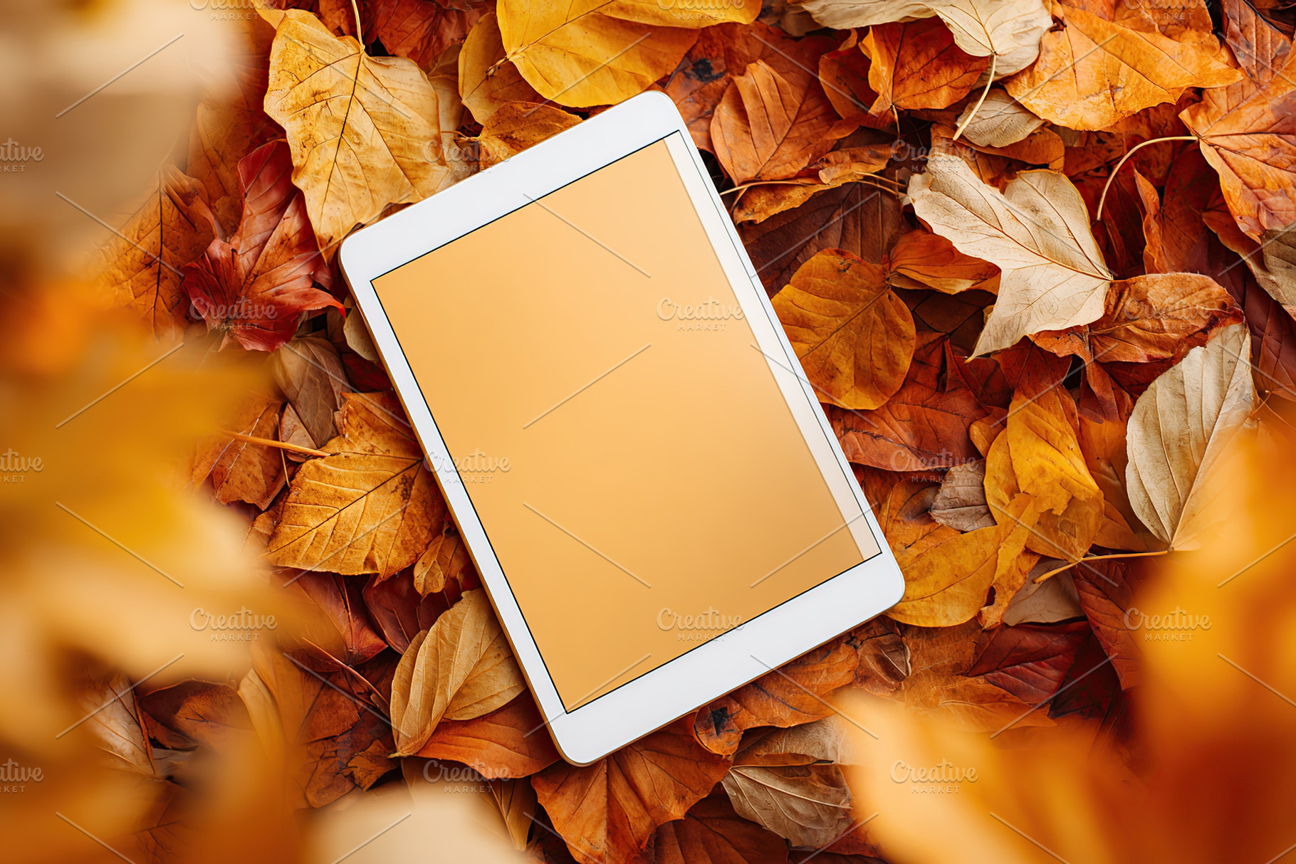 Mockup of a tablet device surrounded by vibrant autumn leaves in a natural sett, a Photo by AlyaAnd