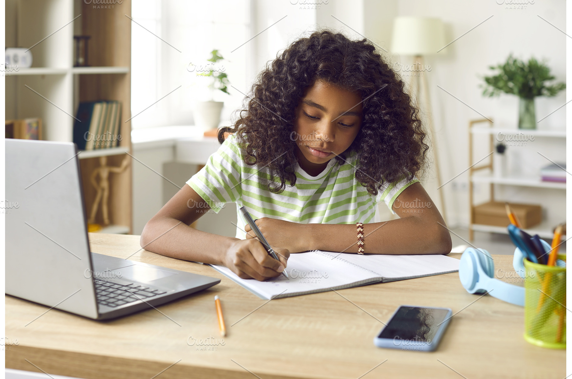 School girl sitting at her desk at, a School & Education Photo by StudioRomantic