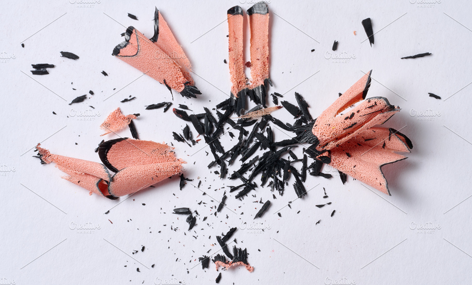Wood shavings from black pencil on white background, top view, a School & Education Photo by ndanko
