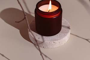 Minimalistic burning candle in a dar, a Photo by Edalin's Store