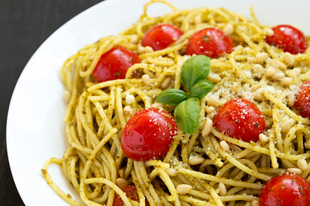 Homemade Pesto Pasta with Tomatoes and Pine Nuts on a black back, a Food & Drink Photo by LiudmylaChuhunova