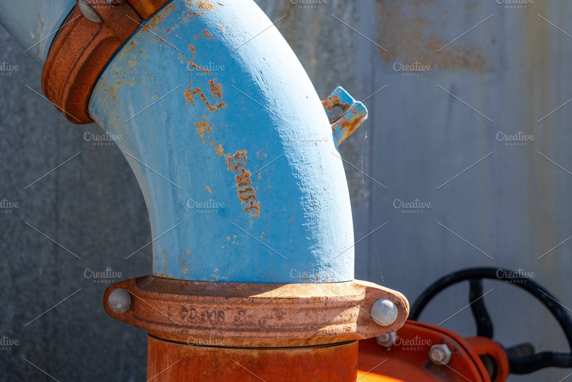 Rusty industrial water pipes with valves and connectors in an ur, a Photo by GoodGoods
