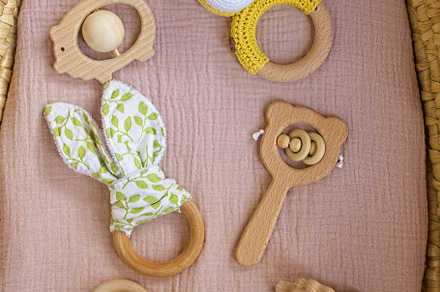 in a basket natural wooden knitted toys for a newborn. View from above