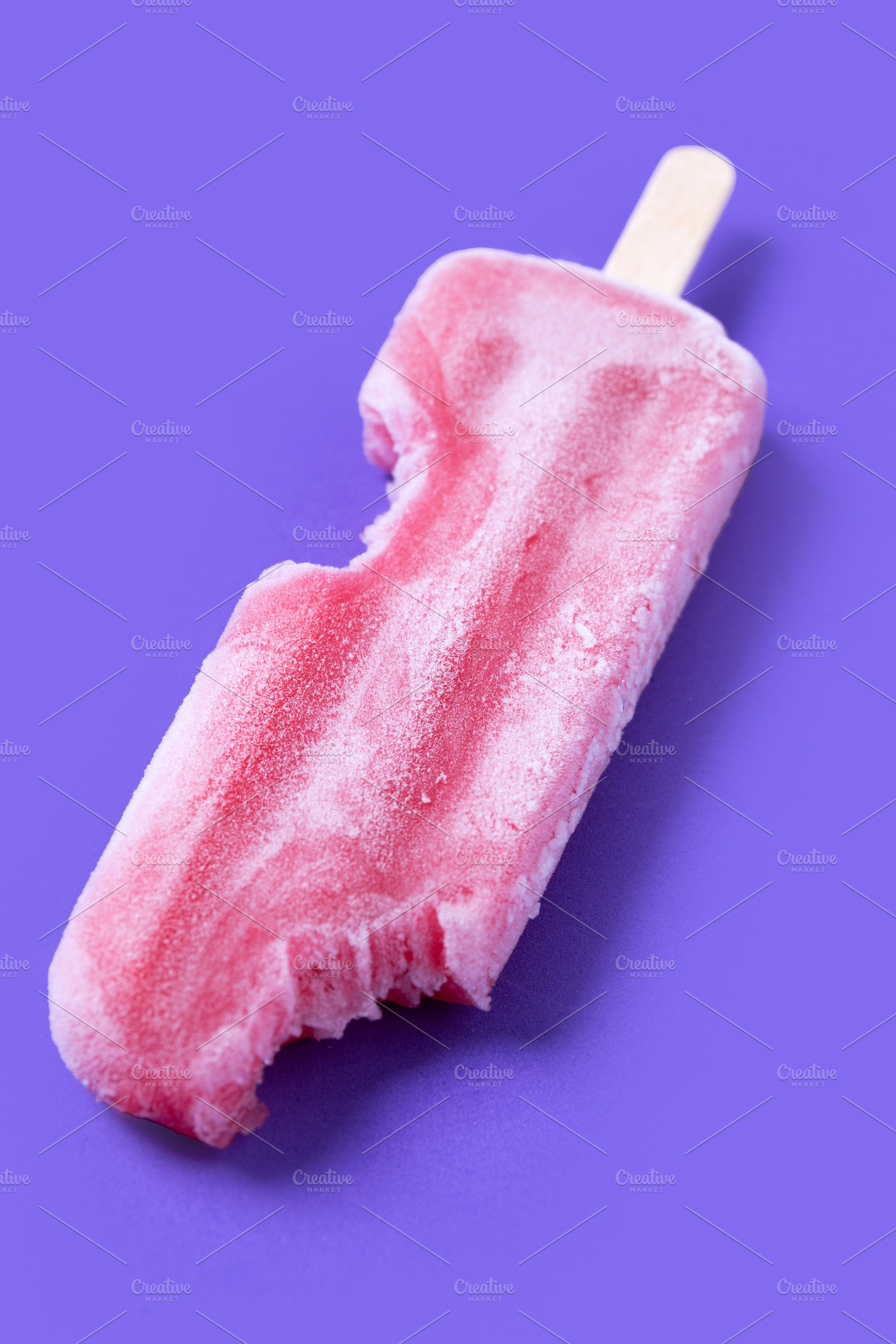 Red strawberry popsicles on purple background. Close up, a Food & Drink Photo by etorres69
