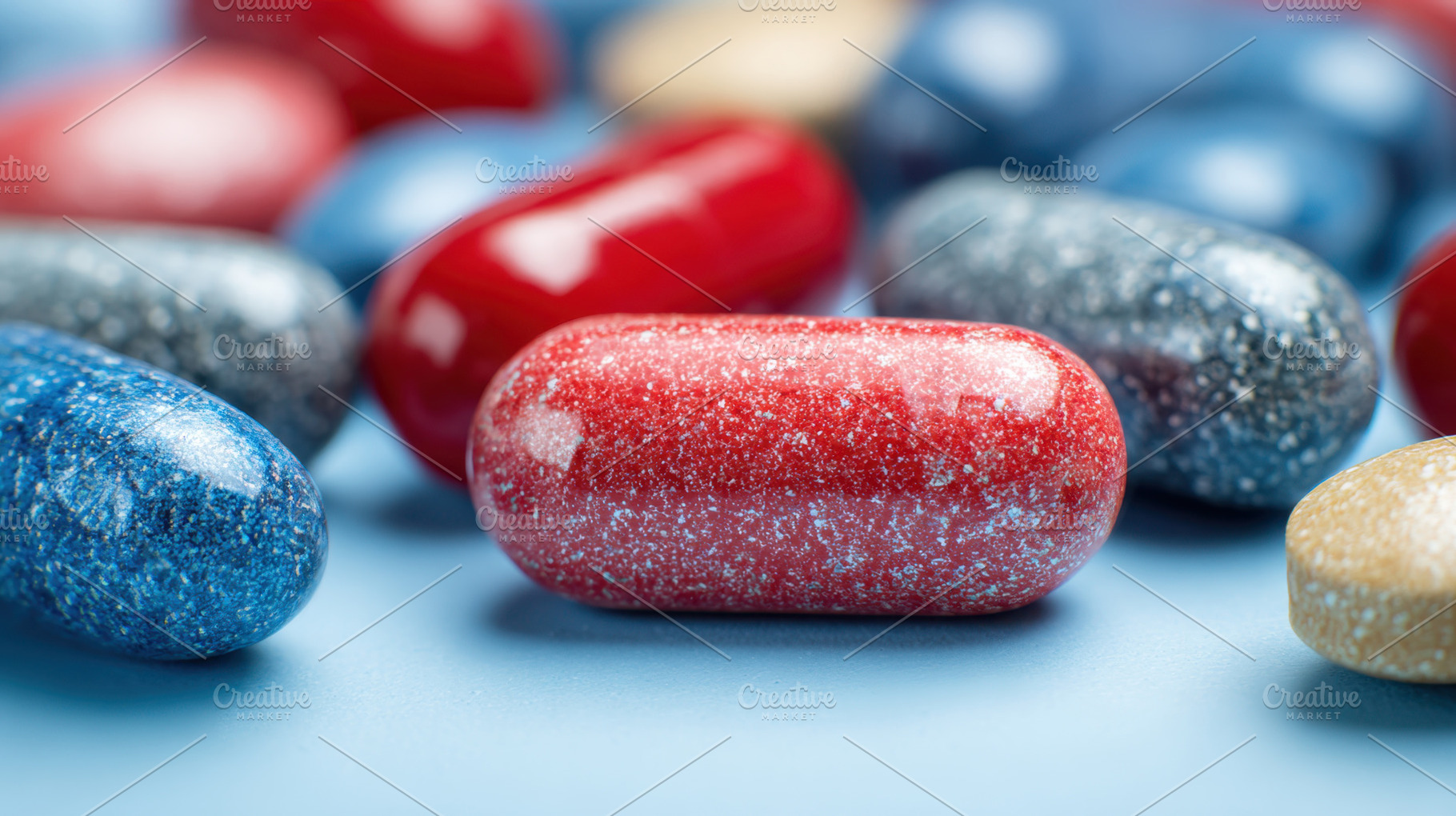 Capsules on blue surface, a Photo by Beautiful things