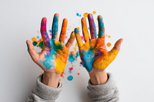 Colorful painted hands with blue and orange paint, an Arts & Entertainment Photo by AlyaAnd