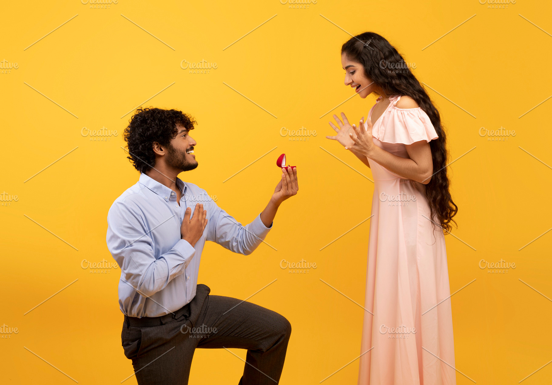 Loving indian man standing on one knee and offering engagement ring to his belo, a Person Photo by Prostock-Studio