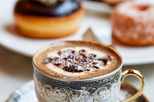 Coffee drink with foam and chocolate art in a fancy porcelain cu, a Food & Drink Photo by Studio ANNA