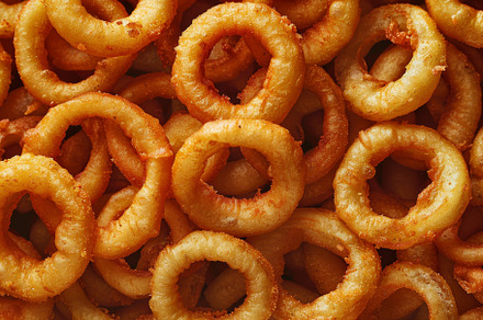 A bunch of crispy onion rings stacke, a Photo by Iftikhar Alam