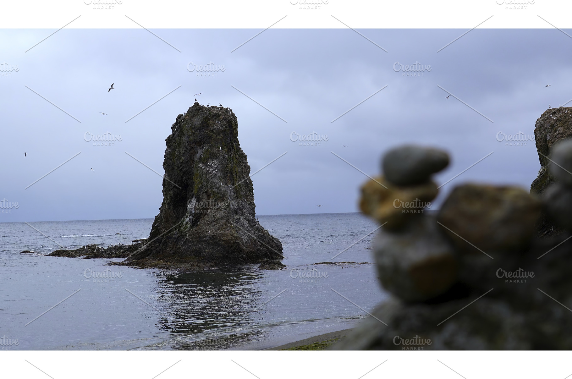 Stones on shore against background, a Nature Photo by Media Whale Stock