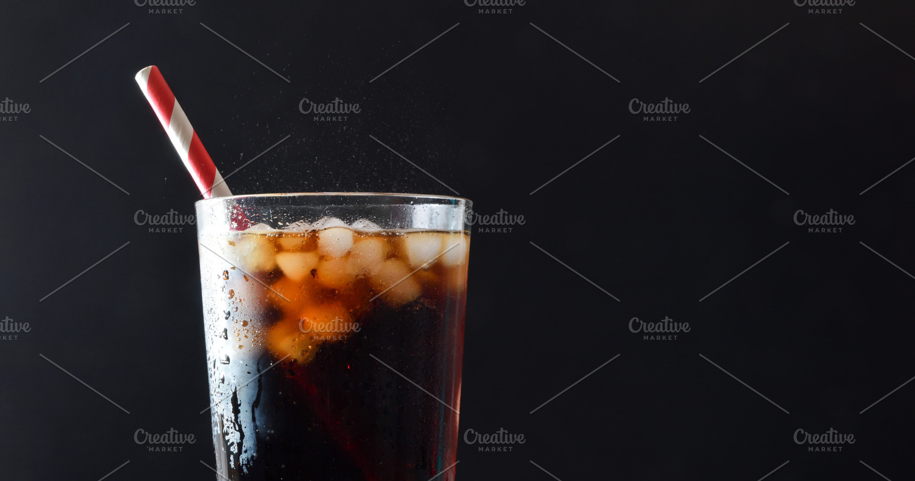 Detail of glass with cola drink with ice isolated background, a Food & Drink Photo by Davizro's Market