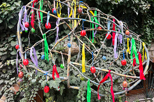 Colorful ribbons and ornaments decorating a spherical metal structure in a gard, a Photo by AS photostudio