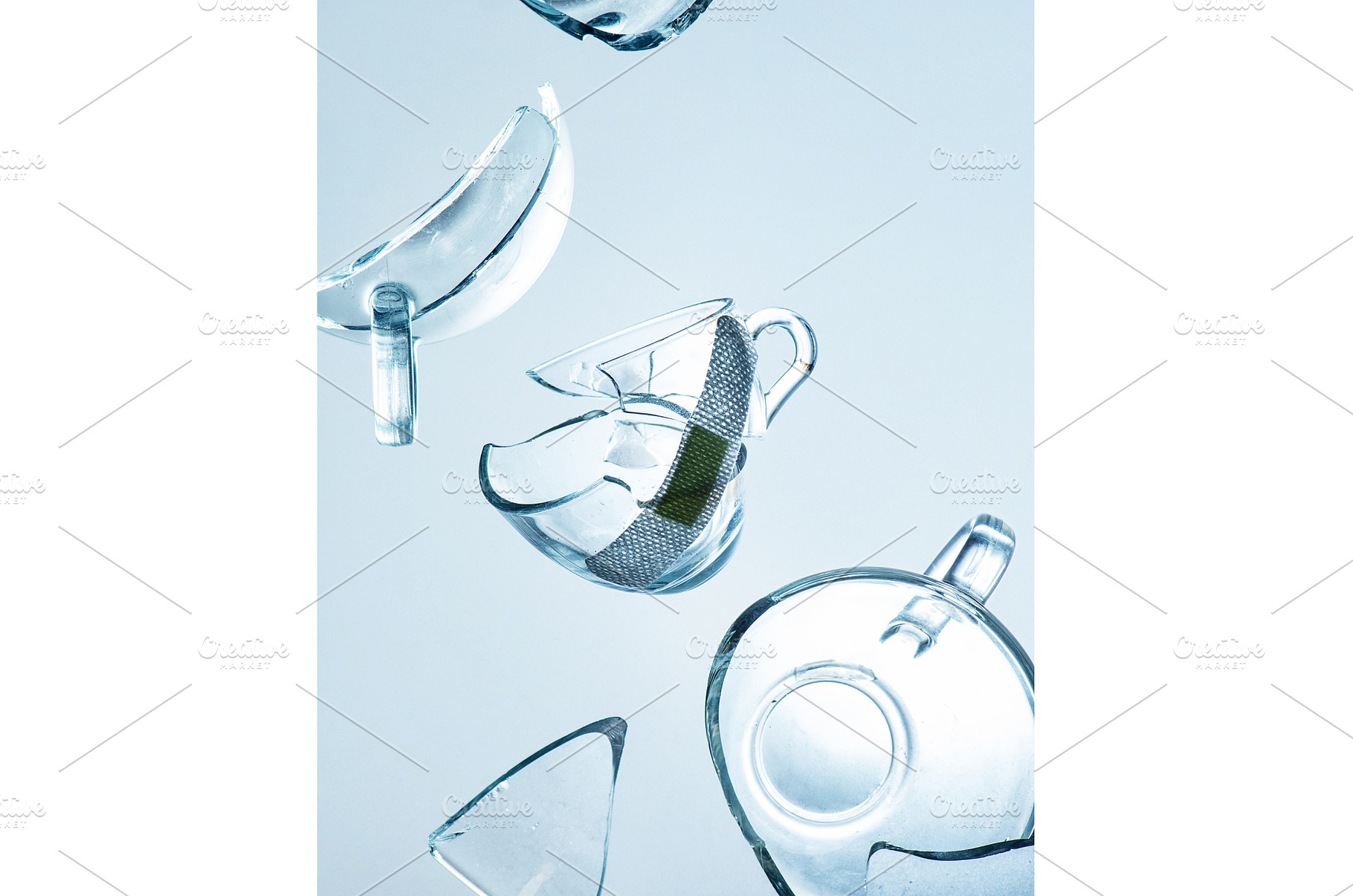Broken cup with a bandage, fragility, an Arts & Entertainment Photo by dinabelenko