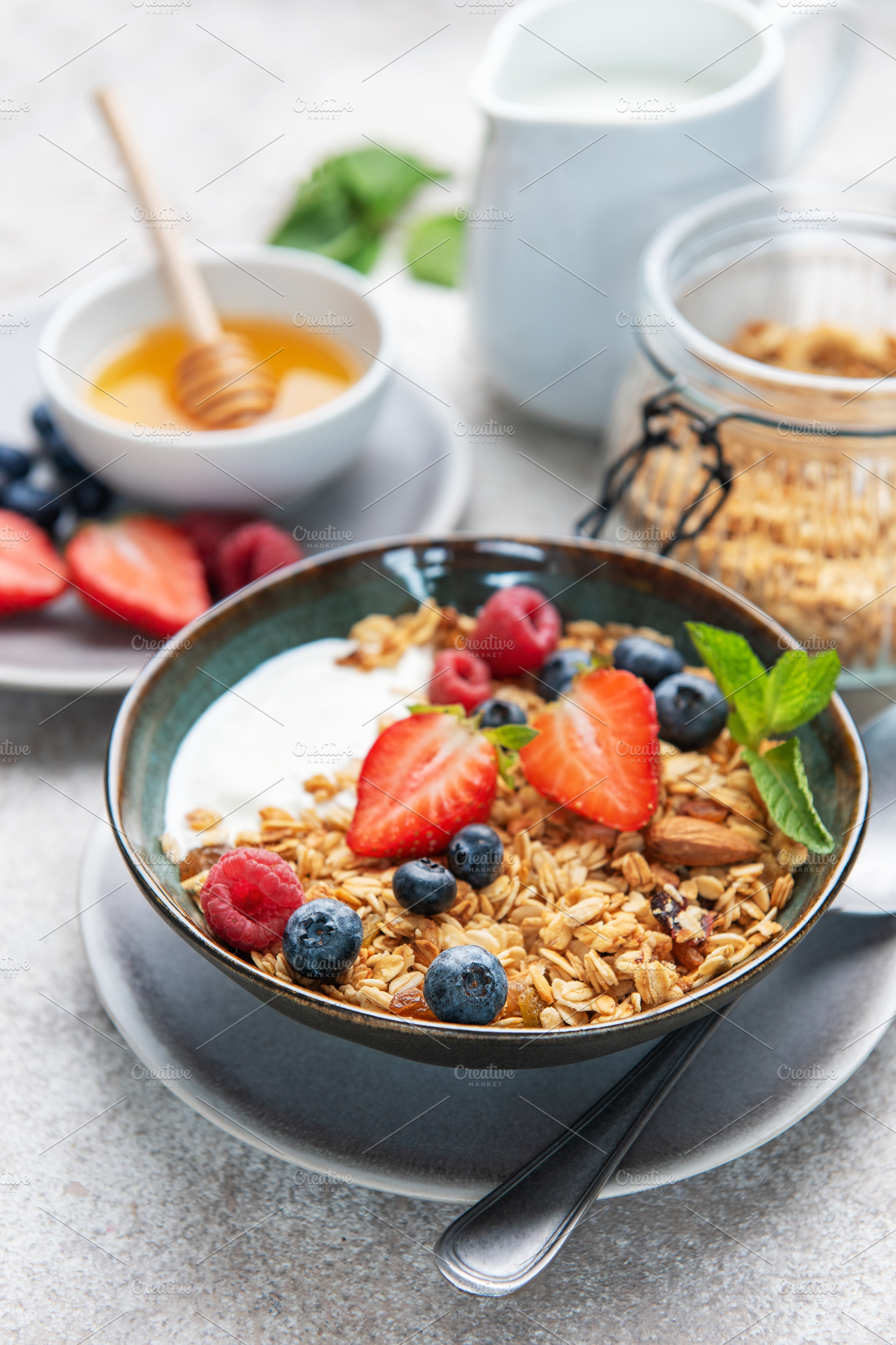 Healthy breakfast bowl with granola, yogurt, and berries, a Food & Drink Photo by Olena Rudo