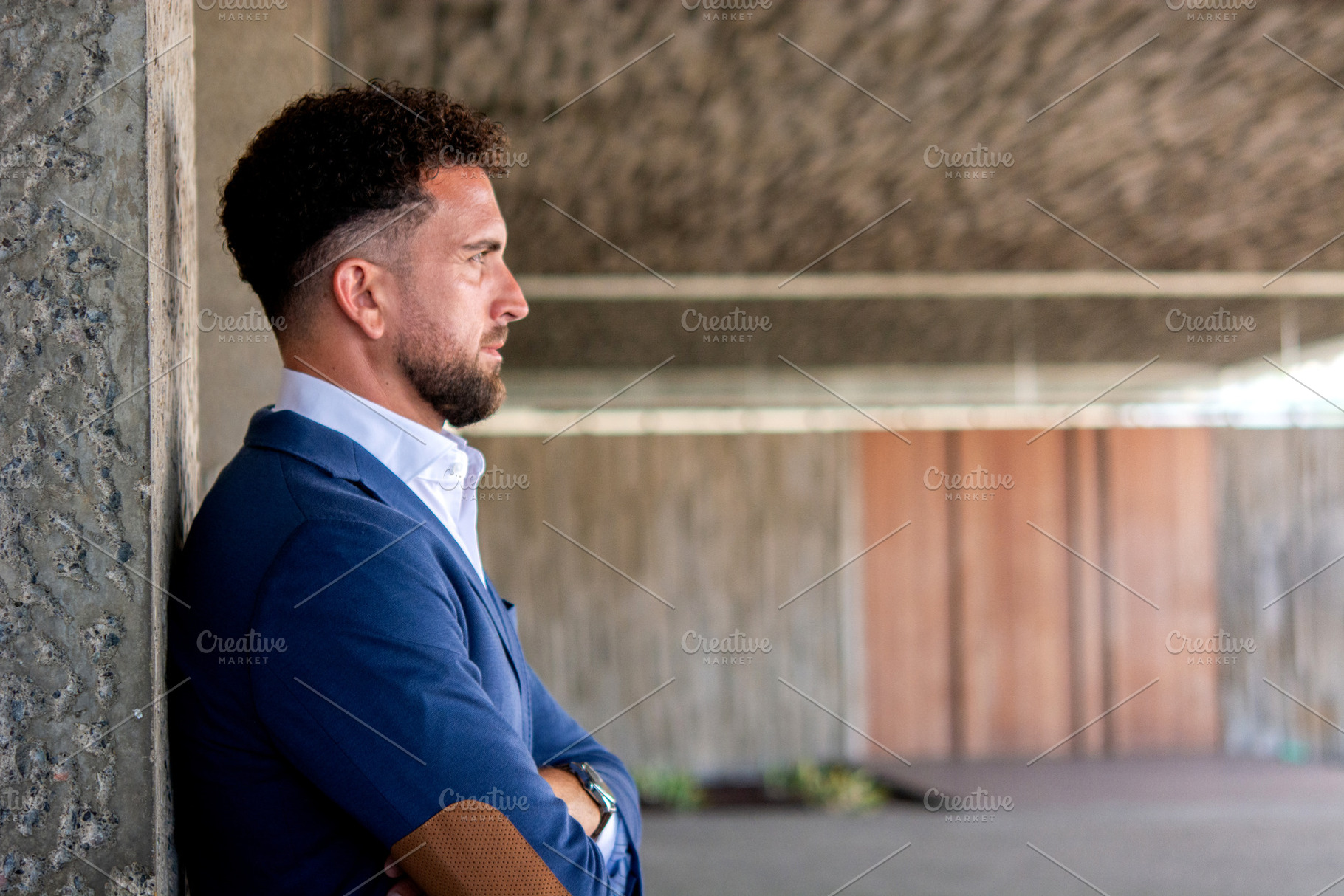 Thoughtful businessman standing with arms crossed outside office, a Business Photo by etorres69
