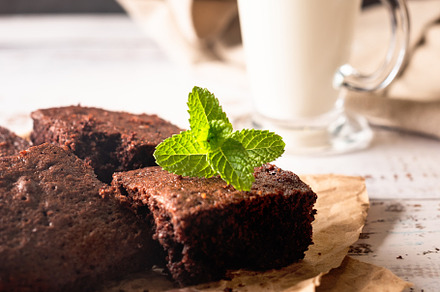 Stack of chocolate brownies with milk glass on dark stone backgr, a Food & Drink Photo by vimart