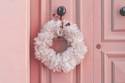 Plastic Christmas wreath on pink