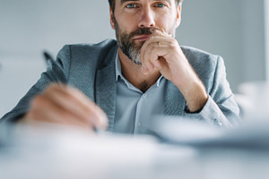 Man pondering in office, a Photo by Beautiful things