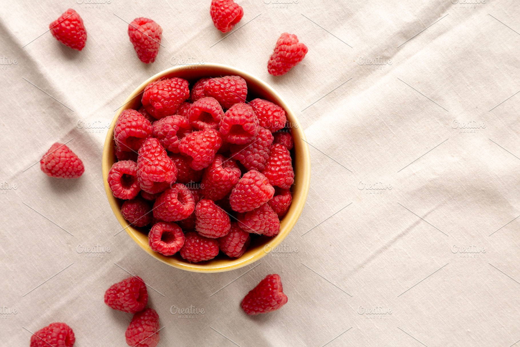 Organic Raw Red Raspberries in a Bowl, top view. Copy space., a Food & Drink Photo by LiudmylaChuhunova