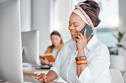 Communication, typing and black woman on a phone call for networking while working on a computer. Contact, connection and African employee talking on a mobile while on a pc for information at work, a Photo by Peopleimages.com