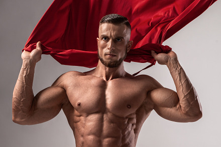 Male bodybuilder puts on his stock photo containing muscle and bodybuilder