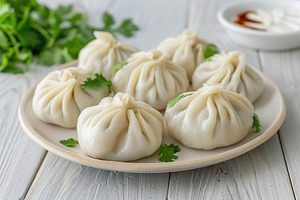 Homemade meat khinkali in plate on wooden table, a Food & Drink Photo by AlyaAnd