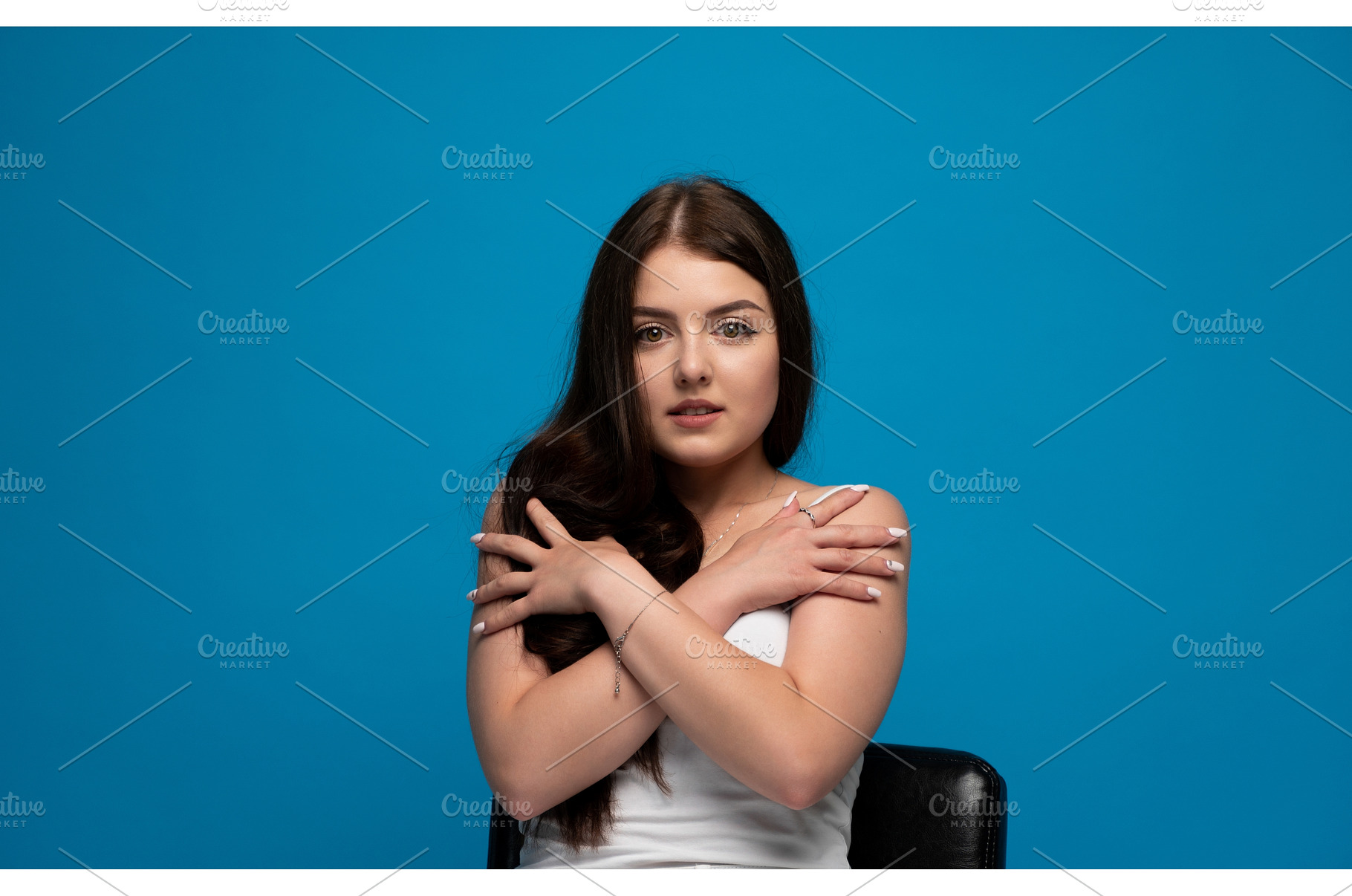 Young woman embracing herself with, a Person Photo by volodymyrshtun13795