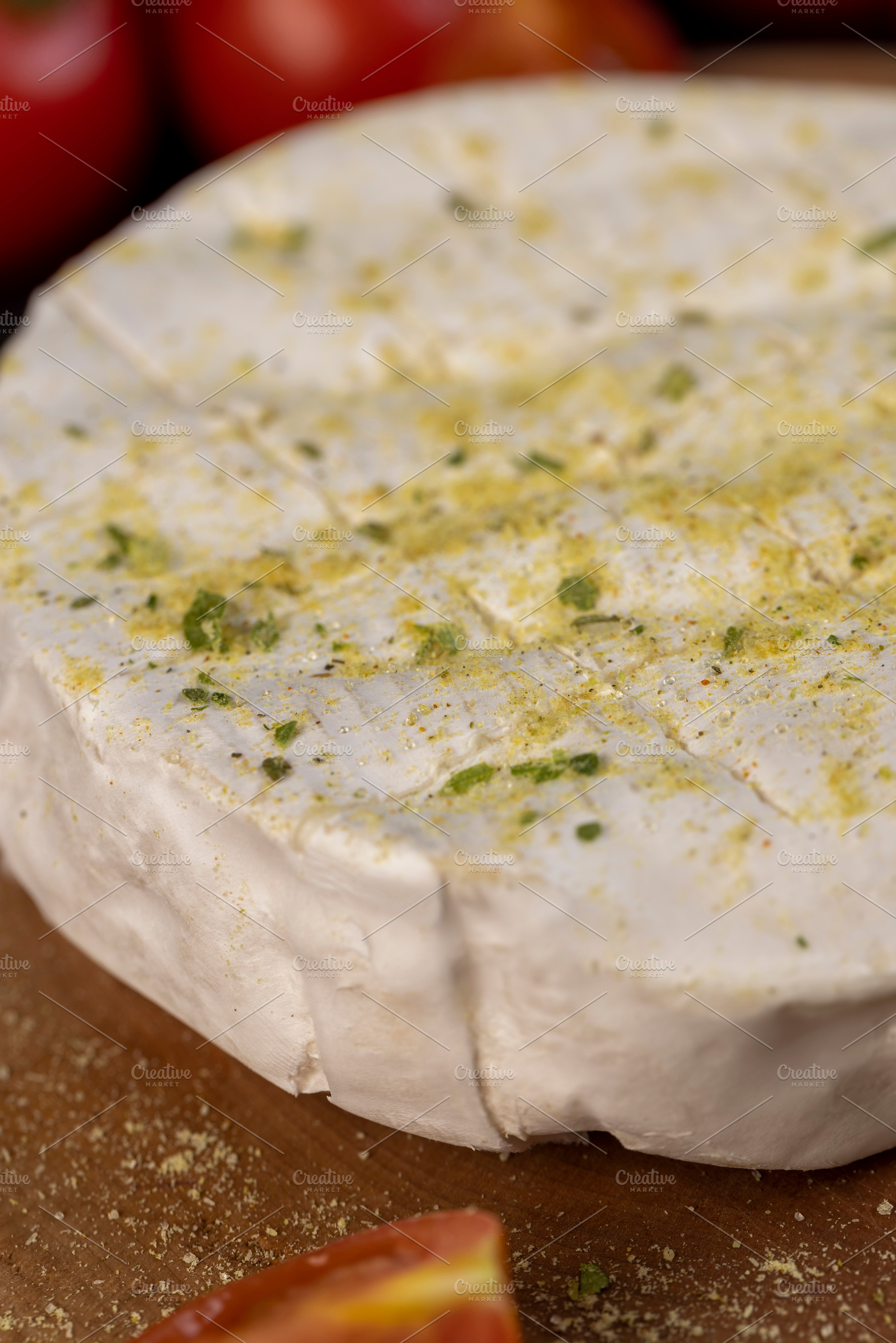 white soft cheese in salt and spices and small red round tomatoes on the table, a Photo by MyPhotos