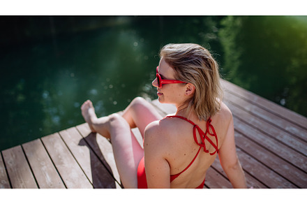 Rear view of young woman in swimsuit, a Nature Photo by HalfPoint